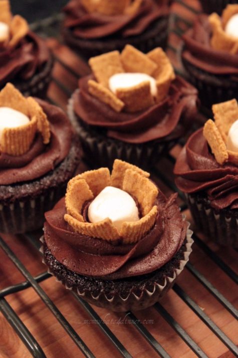 I was running out of icing, so we came up with these s'more cupcakes! My daughter told me to stuff them with a marshmallow, then I took the icing and made a swirl around it, and took some Golden Graham cereal and make a flower or 'fire' for a campfire s'more! I think they turned out cute!